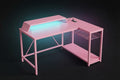 Pink L-shaped gaming desk with teal RGB underglow lighting monitor riser wire shelf and built-in power strip on dark background
