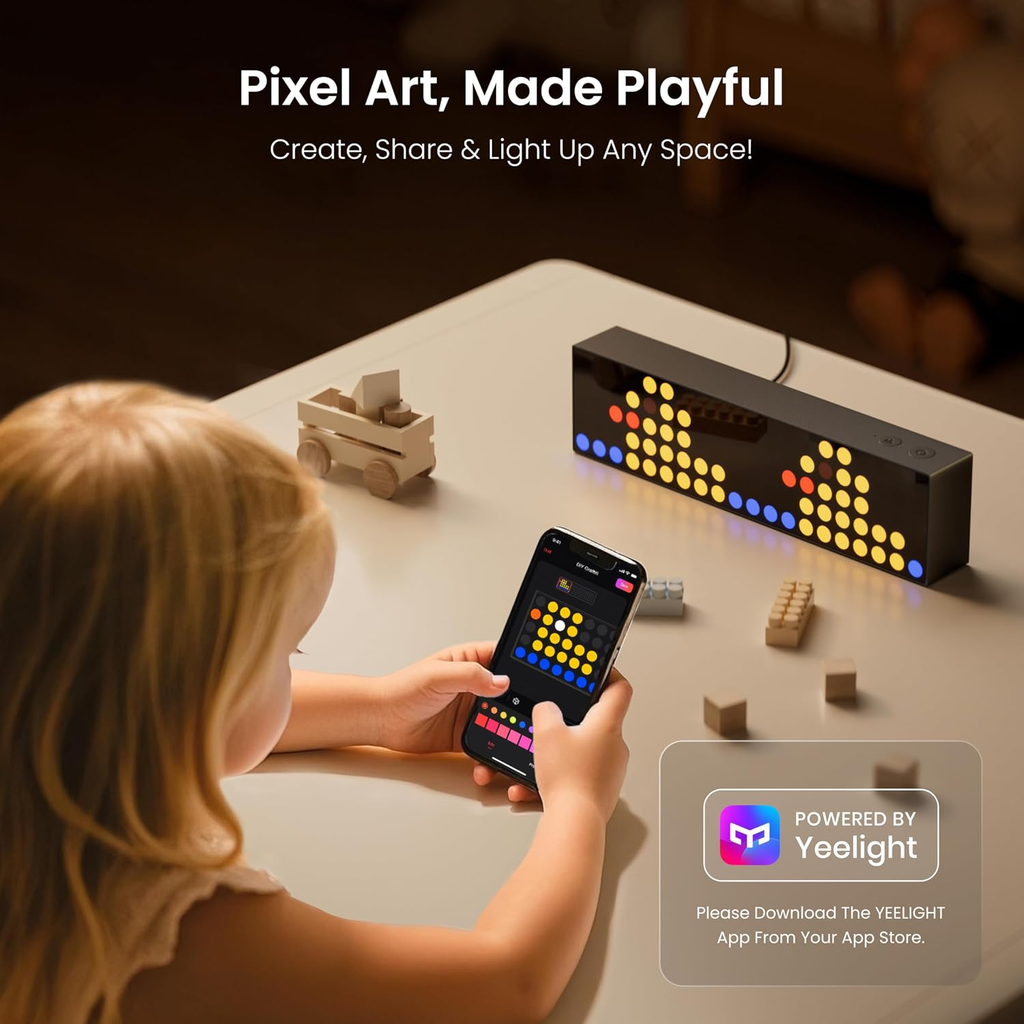 Child using a smartphone to control a pixel art device on a table.
